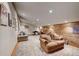 Finished bonus room with comfortable seating and wood accent wall at 934 S Perry Park Rd, Sedalia, CO 80135