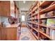 Large walk-in pantry with ample shelving for storage at 934 S Perry Park Rd, Sedalia, CO 80135