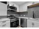 Modern kitchen with stainless steel appliances and white cabinets at 203 Wright St # 208, Lakewood, CO 80228