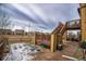 Cozy backyard patio with a fire pit and raised deck at 664 Fossil Bed Cir, Erie, CO 80516