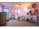 Pink bedroom with white furniture, a desk, and colorful accents at 664 Fossil Bed Cir, Erie, CO 80516