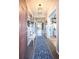 Welcoming entryway with tiled flooring, a bench, and a gallery wall at 664 Fossil Bed Cir, Erie, CO 80516