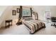 Cozy bedroom with a striped comforter and a view of the woods at 1300 Main St, Georgetown, CO 80444