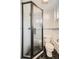 Modern bathroom with a glass shower and black hexagon floor tiles at 1300 Main St, Georgetown, CO 80444