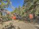 Red barn-style home with mountain backdrop at 1300 Main St, Georgetown, CO 80444