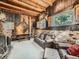 Rustic living room with exposed beams and brick fireplace at 1300 Main St, Georgetown, CO 80444