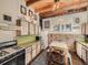 Unique kitchen featuring wood cabinets, brick walls, and a microwave at 1300 Main St, Georgetown, CO 80444