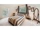 Bright bedroom with a striped comforter and large windows at 1300 Main St, Georgetown, CO 80444