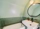 Modern bathroom with green tile and a white sink at 1300 Main St, Georgetown, CO 80444