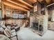 Rustic living room with exposed beams and brick fireplace at 1300 Main St, Georgetown, CO 80444
