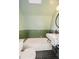 Stylish bathroom with green tile, a white sink and geometric floor at 1300 Main St, Georgetown, CO 80444