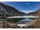 Scenic view of a partially frozen lake with snow-covered mountains in the background at 1300 Main St, Georgetown, CO 80444