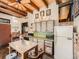 Rustic kitchen with wood cabinets, brick accents, and a farmhouse table at 1300 Main St, Georgetown, CO 80444