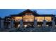 Luxury home exterior at dusk, stone facade, large windows at 7474 Spring Drive, Boulder, CO 80303