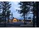 Mountain home with stone exterior, large windows, and a three-car garage at 7474 Spring Drive, Boulder, CO 80303