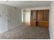 Living room with carpeted floors and built-in wooden cabinetry at 912 S Peoria St, Aurora, CO 80012