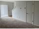 Living room features carpeted floors, a door, and a view of a staircase at 912 S Peoria St, Aurora, CO 80012