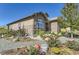 Landscaped front yard with colorful flowers and stone pathway at 15797 Fishers Peak Dr, Broomfield, CO 80023