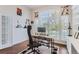 Home office with built-in shelving and large window with plantation shutters at 15797 Fishers Peak Dr, Broomfield, CO 80023