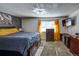 Main bedroom with a king-size bed, dresser, and window with yellow curtains at 13969 E Utah Cir, Aurora, CO 80012