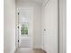 Bright hallway with light wood floors and doors to bedrooms and bathroom at 1411 Zenobia St, Denver, CO 80204