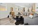 Open living area with light hardwood floors, gray sofa, and kitchen island at 1411 Zenobia St, Denver, CO 80204