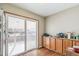 Kitchen with wooden cabinets, granite counters, and backyard access at 4511 W Ponds Cir, Littleton, CO 80123