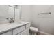 Modern bathroom with white vanity, shower, and wood-look flooring at 3352 N Highlands Creek Pkwy, Aurora, CO 80019