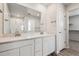 Modern bathroom with double vanity, walk-in shower, and walk-in closet at 3352 N Highlands Creek Pkwy, Aurora, CO 80019