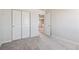 Empty bedroom with closet, carpet flooring, and open door leading to another room at 3352 N Highlands Creek Pkwy, Aurora, CO 80019
