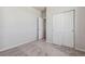 Spacious bedroom with carpeted flooring, closet, and access to another room at 3352 N Highlands Creek Pkwy, Aurora, CO 80019