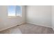 Cozy bedroom with carpeted flooring and a large window at 3352 N Highlands Creek Pkwy, Aurora, CO 80019