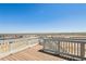 Wooden deck with white railing offers views of the surrounding landscape at 3352 N Highlands Creek Pkwy, Aurora, CO 80019