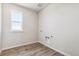 Laundry room with window, washer/dryer hookups, and utility sink at 3352 N Highlands Creek Pkwy, Aurora, CO 80019