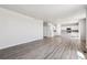 Open-concept living area with wood-style flooring and view of the kitchen at 3352 N Highlands Creek Pkwy, Aurora, CO 80019