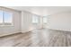 Bright living room with large windows and wood-style flooring at 3352 N Highlands Creek Pkwy, Aurora, CO 80019