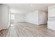 Spacious living room with wood-style flooring and adjacent kitchen at 3352 N Highlands Creek Pkwy, Aurora, CO 80019