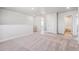 Carpeted loft area with access to a bathroom and other rooms at 3352 N Highlands Creek Pkwy, Aurora, CO 80019