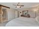 Main bedroom with king bed, dresser, and access to bathroom at 3536 Evening Pl, Castle Rock, CO 80109