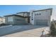 Modern two-story home with a three-car garage and a paved driveway at 3564 Doubletrack Ln, Castle Rock, CO 80108