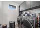 Well-equipped laundry room with modern washer and dryer and ample storage cabinets at 3564 Doubletrack Ln, Castle Rock, CO 80108