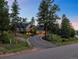 Mountain home with a large driveway and landscaped yard at 4532 Shoshone Dr, Larkspur, CO 80118