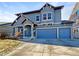 Two-story house with blue exterior, three-car garage, and landscaping at 4828 Ceylon Way, Denver, CO 80249