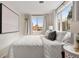 Charming bedroom with a queen-size bed and large windows at 1516 Lafayette St, Denver, CO 80218