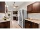 Modern kitchen with stainless steel appliances and dark wood cabinets at 1516 Lafayette St, Denver, CO 80218