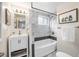 Modern bathroom with a bathtub, shower, and white vanity at 1516 Lafayette St, Denver, CO 80218