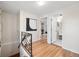 Light-filled hallway with hardwood floors and access to bathroom and bedroom at 1516 Lafayette St, Denver, CO 80218