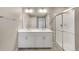 Modern bathroom with double vanity, a large mirror, and shower at 18261 Field Mint Pt, Parker, CO 80134