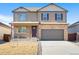 Two-story house with stone accents and a two-car garage at 18261 Field Mint Pt, Parker, CO 80134