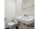 Simple bathroom with a toilet and a pedestal sink at 1289 S Monaco Pkwy, Denver, CO 80224